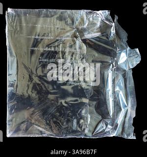Torn heat shrink plastic wrap packaging on black background with clipping path Stock Photo
