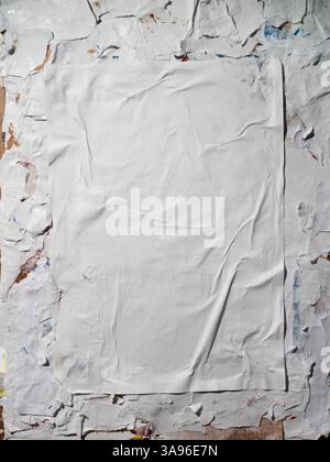 Vertical Wheatpaste poster style texture on a dirty wall Stock Photo