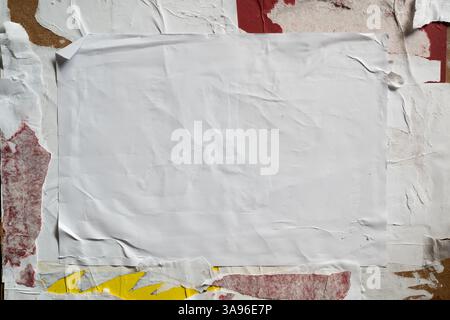 Wheatpaste poster style texture on a dirty wall Stock Photo