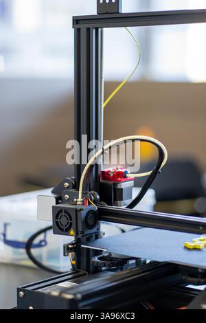 View of a working 3D printer mechanism printing a plastic part Stock Photo