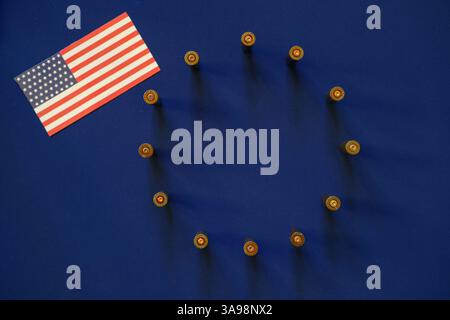 Circle of bullet casings on a blue background of the European Union's flag. Metaphor of the European Union's growing focus on armament and defense. Stock Photo