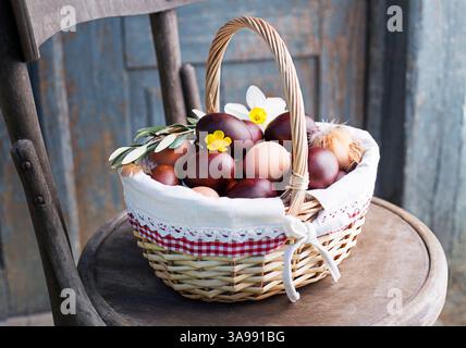 Brown Easter eggs dyed with onion peels  in a basket. Holidays traditional background Stock Photo