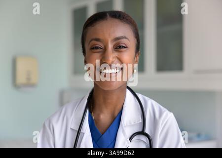 Cheerful beautiful African doctor looking at camera with toothy smile Stock Photo