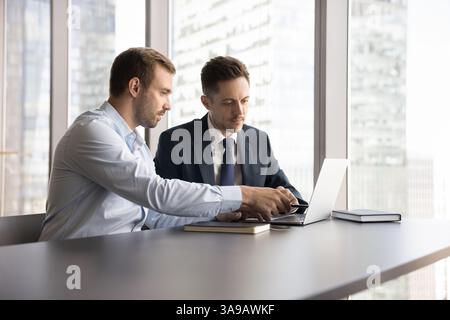 Colleagues working together on joint project or task Stock Photo