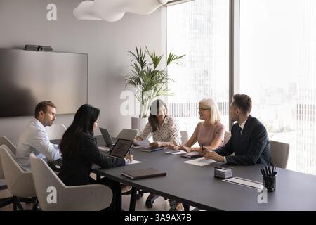 Group of professionals discussing business matters, strategy, or project details Stock Photo
