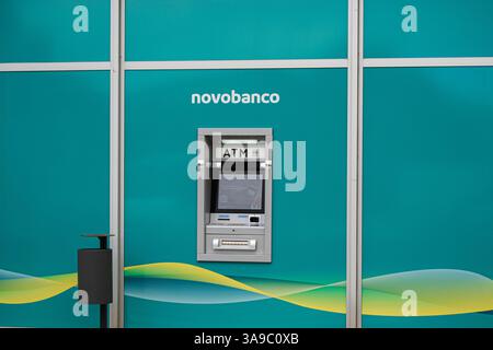 Fatima, Portugal - March 24, 2025: Bank Novobanco ATM located in Fatima, Portugal featuring a bright green background. Stock Photo