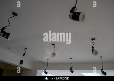 Image showing a ceiling under work with multiple recessed spotlight fixtures being newly installed Stock Photo