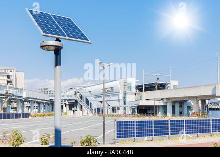 Modern city with saving energy LED Solar power street light, Solar wall system using in public area at Japan developed country Stock Photo