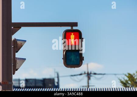 Red people traffic light for signal Pedestrian waiting or stop passing no cross the road in Japan Stock Photo