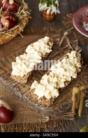 Two slices of bun with bread spread made of leftover Easter eggs in spring Stock Photo