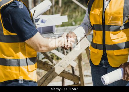 Closeup Professional engineer male handshake with team builder contractor acquisition and successful negotiate, Shake hand with partner dealing constr Stock Photo