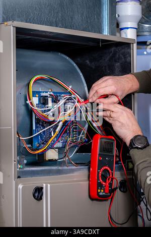 Voltmeter used by electrician to fix a home furnace Stock Photo