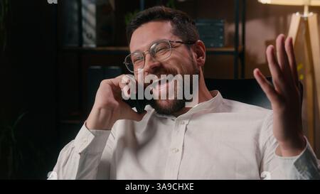 Joyful Caucasian agent guy lawyer leader worker calling mobile phone executive speaking in office connect ceo employee man discussing business startup Stock Photo