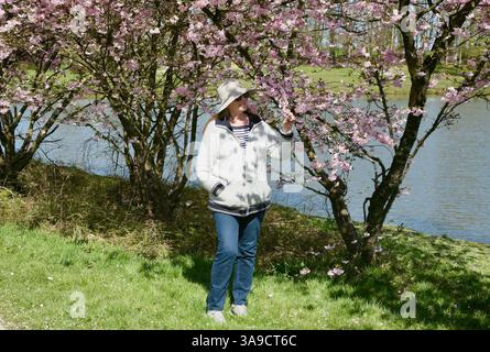 A lady at the lakeside in France Stock Photo