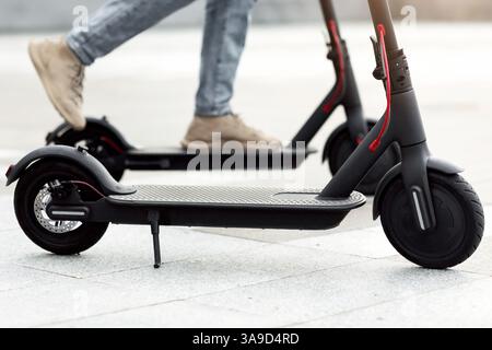 Person having pleasant ride on electric kick scooter Stock Photo