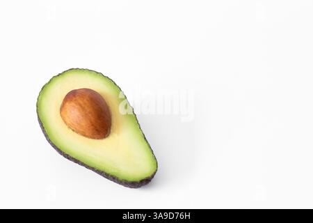 Ripe avocado cut. Avocado cut in half isolated on white background, clipping path. Avocado good fats. Nobody, copy space for text Stock Photo