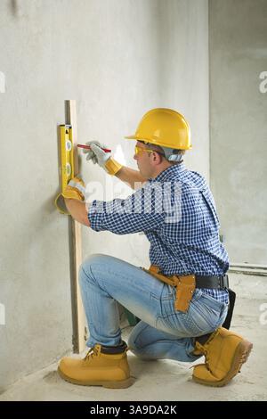 Builder at concrette wall Stock Photo