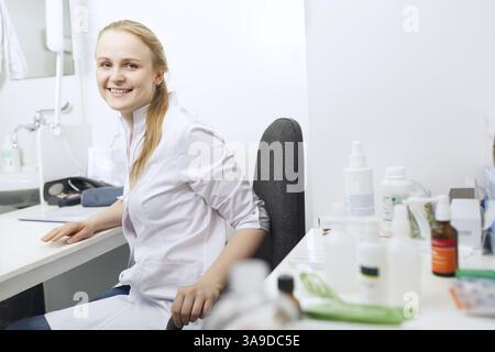 Female doctor smiling and looking to the photographer Stock Photo