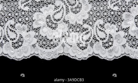 White lace with pattern in the manner of flower on black background Stock Photo