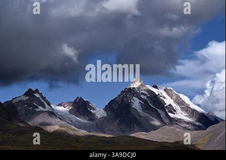 Snowy mountains and storm clouds in the Vilcanota mountain range. Pacchanta, Cusco, Peru Stock Photo