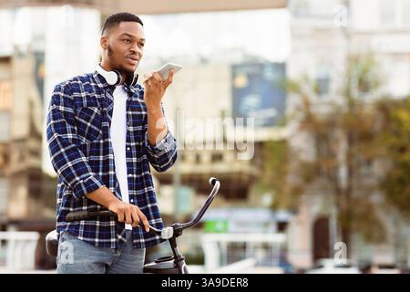 Portrait of black man talking on phone using speaker Stock Photo