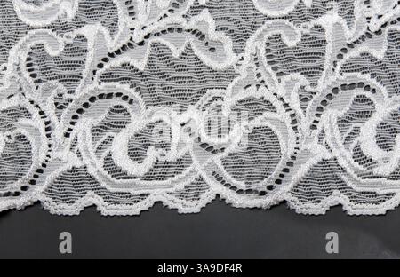 White lace with pattern in the manner of flower on black background Stock Photo
