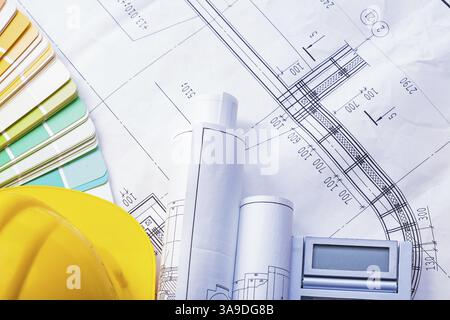 yellow helmet rolled blueprints calculator color palette Stock Photo ...