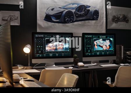 Two computers with 3d graphic car models on screens standing on workplaces of modern engineers in coworking space Stock Photo