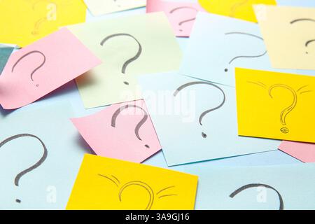 Different sticky notes with question marks on color background, closeup Stock Photo