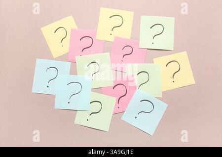 Different sticky notes with question marks on color background Stock Photo