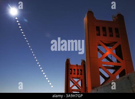 A multiple exposure shows the progression of the moon passing between the earth and sun during a partial solar eclipse as viewed from the east side of the Sacramento River near the Tower Bridge on Monday, June 10, 2002.  The photo is a multiple exposure taken over the span of two hours. Each exposure was taken five minutes apart through a special filter which cuts down the suns light by 100,000 times allowing the film to record the crescent shape of the sun as the moon passed before it.  2321 (SacramentoBee/ Randall Benton)/ZUMA Press Stock Photo