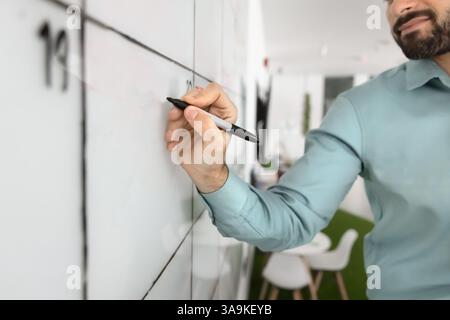 Business project executive leader man writing notes on whiteboard Stock Photo