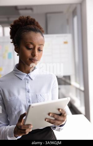 Serious young African businesswoman working on Internet startup Stock Photo