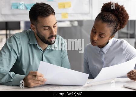 Serious customer showing documents to legal expert Stock Photo