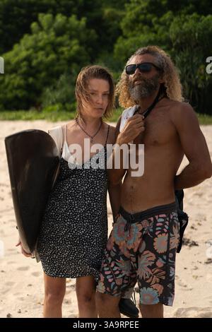 Friends with surfboard standing at beach Stock Photo