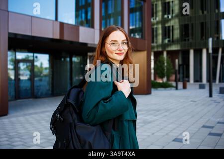 Ginger girl student in glasses with a backpack close up portrait Stock Photo