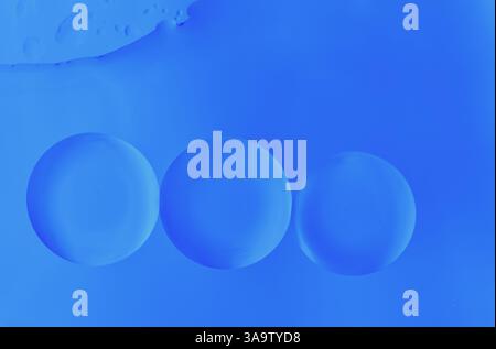Macro image of translucent liquid spheres in vibrant blue. Abstract background for science, beauty, or design projects. Stock Photo