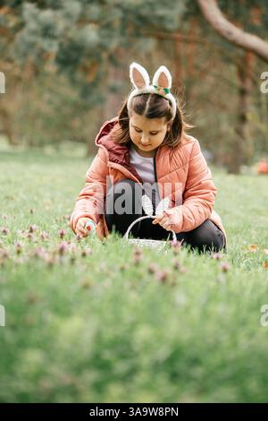 Craft display featuring handmade bunny decoration amidst colorful Easter-themed ornaments on a wooden table Stock Photo
