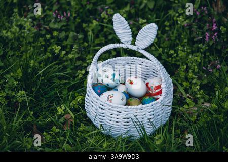 Colorful Easter decorations with painted eggs and a bunny centerpiece arranged on a festive table Stock Photo