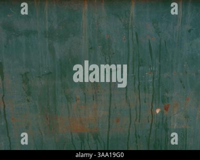 Close-up of weathered metal surface with green paint, rust stains, and streaks of oxidation. Rough texture and corrosion marks, industrial, aged look. Stock Photo