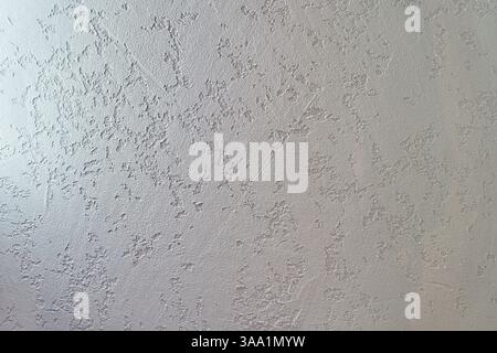 Uneven background with the texture of decorative plaster painted in white concrete wall. Rough wall with space for copying. High quality photo Stock Photo