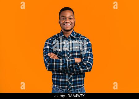 Black Man Posing Crossing Hands Standing In Studio Stock Photo