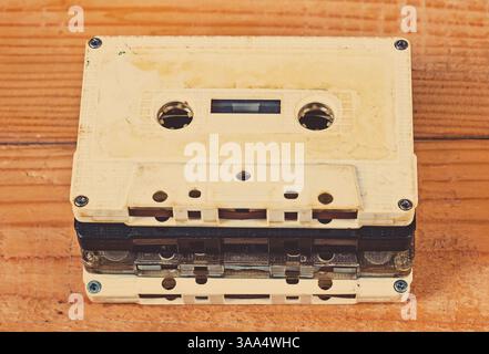 Toned Photo of Old Audio Cassettes on a Wooden Planks Background closeup Stock Photo