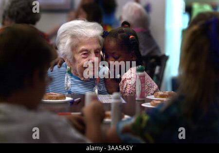 Rose Dickstein (cq), 91, is hugged by Aunschelle Jackson (cq), 8, at the Albert Einstein Residence Center in Sacramento on Wednesday, August 22, 2001 as they take a break during a bingo game. The seniors were interacting with kids from Thomas Jefferson Elementary School's 4th ''R'' program. Kids from the school's kindergarten through 6th grade class dance the chicken dance with residents and volunteers and also perform a Hula dance and played bingo. The 4th ''R'' program is run through the City of Sacramento's School-age Child Care Center. (Sacramento Bee/Jose M. Osorio)  The Sacramento Bee/ZU Stock Photo