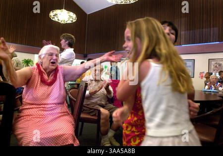 Helen Thompson, 80, far left, reacts after finishing the chicken dance at the Albert Einstein Residence Center in Sacramento on Wednesday, August 22, 2001. The seniors were interacting with kids from Thomas Jefferson Elementary School's 4th ''R'' program. Kids from the school's kindergarten through 6th grade class dance the chicken dance with residents and volunteers and also perform a Hula dance. The 4th ''R'' program is run through the City of Sacramento's School-age Child Care Center. (Sacramento Bee/Jose M. Osorio)  The Sacramento Bee/ZUMA Press Stock Photo