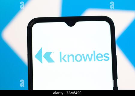 In this photo illustration, the Knowles logo is seen displayed on a ...