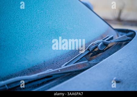 Car windshield and wipers covered with frost close-up. Stock Photo