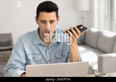 Man holding smartphone lead conversation using speakerphone Stock Photo