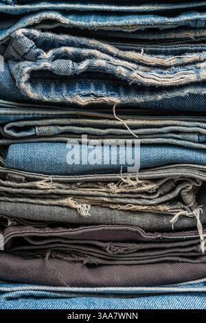 Stack of blue and gray jeans. Background with jeans texture. Denim background Stock Photo
