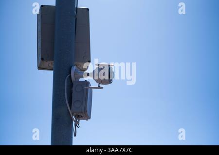 CCTV camera on pole with blue sky background, security concept Stock Photo